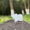 Estatua de elefante tallada en ágata blanca natural sobre una piedra con textura - Cristal de roca