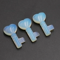 Translucent heart-shaped opalite key carvings with smooth polished finish and blue glow - Opal