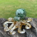 Green crystal stone octopus figurine with gold leaf accents on a grey stone base - Green Aventurine
