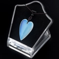 Polished opal stone heart pendant with blue glowing highlights on a black cord - Opal (Synthetic)