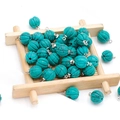 Pumpkin shaped turquoise pendant with silver metal ring on light wood tray - Blue Turquoise (Synthetic)