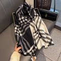 Detailed close-up of thick black and white plaid scarf with lockstitch edges in a gift box - 53*192cm / Black