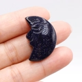 Blue sandstone crescent moon pendant with double-sided face carving and starry glitter - Blue Sand Stone (Synthetic)