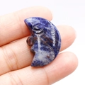 Natural sodalite crystal moon face carving in deep blue and white stone pattern - Blue Sodalite