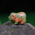 Miniature hand-carved unakite stone pig figurine with natural green and orange patterns - Unakite