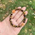Handheld Tiger Eye beaded bracelet with orange skull charms and silver spacers - Tiger's Eye