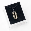 Oval dalmatian jasper stone ring pendant with black woven cord on display stand - With Rope / Dalmatian Jasper