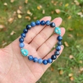 Lapis lazuli natural stone beaded bracelet featuring blue turquoise skull charms - Blue Sodalite