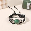 Multilayer leather wrap bracelet featuring a round green gemstone and adjustable cord - Green Aventurine