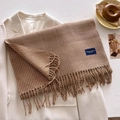 Close-up of brown checkered scarf with fringe detail and an Elegant & Classic label - One Size (53*204cm) / Tan