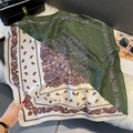 Detail of dark green and cream paisley print silk-like scarf on a luxury texture - FW-141-Green