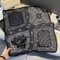 Detail of black and white paisley print square silk scarf on soft white plush background - FW-142-Black