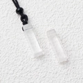 Rectangle natural white crystal pendant with black cord on a textured white background - White Crystal