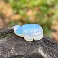 Miniature opalite turtle carving with iridescent finish on a natural rock setting - Opal (Synthetic)
