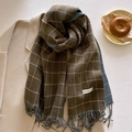 Detailed view of dark olive plaid scarf with fringe and a grey double-sided lining - Olive Green