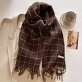 Close-up of dark brown plaid tassel scarf with soft cashmere-like texture on coat - Coffee Brown