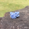 Blue and white sodalite hand-carved squirrel miniature figurine on a dark stone - Blue Spot Stone