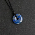 Lapis Lazuli donut pendant with deep blue natural texture on black braided cord - Lapis Lazuli