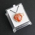 Heart-shaped red stone pendant with golden wire wrapping and butterfly in a clear box - Red Jasper
