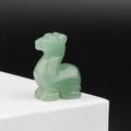 Hand-carved green aventurine stone animal figurine displayed on a white stand - Green Aventurine