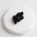 Polished black obsidian crocodile stone carving figurine on white display stand - Obsidian