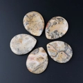 Five polished waterdrop-shaped Crazy Lace Agate stones with unique natural band textures - Crazy Agate