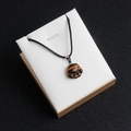 Tiger eye natural stone pendant featuring a cute cat paw carving with black wax cord - Tiger's Eye