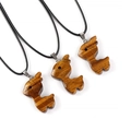Three tiger eye stone reindeer pendants with black cords on a white background - Tiger's Eye