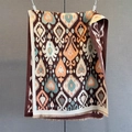 Detailed view of paisley pattern shawl with fringe edges and warm cashmere feel - Brown