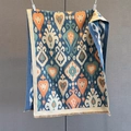 Detailed view of vintage heart pattern scarf with fringe trim and ikat weaving texture - Blue