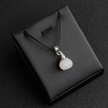Minimalist white crystal pumpkin wizard hat pendant with silver trim on black cord - Agate