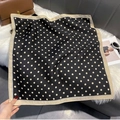 Close-up of elegant black polka dot square scarf draped on a white faux fur texture - FW-166-Black