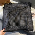 Close-up of black square scarf with white polka dots and paisley border on plush decor - FW-167-Black