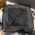 Detailed view of polka dot silk scarf with F-pattern on soft faux fur background - FW-169-Black