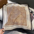 Detailed view of paisley patterned square silk scarf draped over a classic leather bag - FW-194-Coffee Border