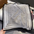 Detail of square silk scarf with black and white paisley patterns on plush carpet - FW-194-Black Grey