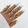 Bohemian gold ring set with butterfly and heart motifs on model hand over white fabric - Bohemian Stacking Gold Style (25432-gold)