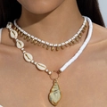 Close-up of double-layer beaded necklace featuring seashell and gold conch charms on a neck - Double-Layer White Gold Conch Pendant (31421-nek-G)