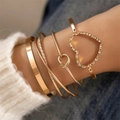Close-up of five-piece gold bracelet set featuring heart charm and twisted patterns - Wide Face and Knot Heart 5-Piece Set (25560-gold) / Gold
