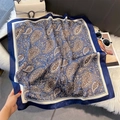 Detail of silk-like square scarf with blue paisley print on soft faux fur background - 70x70cm / Blue Edge (W-441)