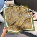 Detail of paisley silk scarf in emerald and gold silk fabric draped on fuzzy texture - 70x70cm / Yellow-Green Edge (W-441)