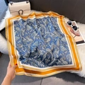 Detailed close-up of dark blue paisley print silk scarf with orange striped border details - 70x70cm / Orange (W-443)