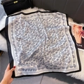 Detailed view of black and white paisley silk square scarf on a soft textured background - 70x70cm / Satin White (W-444)
