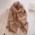 Detail of warm orange houndstooth scarf with tassels on elegant beige coat background - Brown Green