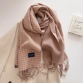 Classic pink and brown houndstooth scarf with fringe over a wool coat in a cozy setting - Pink Brown
