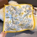 Detail of silk square scarf with blue tulips and yellow borders on a white fur rug - 70cmx70cm / Yellow (W-415)