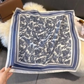 Detail of dark blue and white paisley silk scarf displayed on a soft plush background - 70cmx70cm / Navy (W-418)
