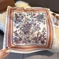 Detail of silk-like square scarf featuring elegant floral butterfly patterns and geometric borders - 70cmx70cm / Light Brown (W-423)