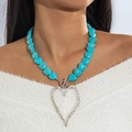 Detail view of heart pendant beaded necklace with turquoise stones and silver toggle clasp - Blue (Turquoise Bead Chain Silver Heart)