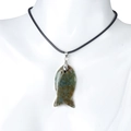 Fish-shaped natural moss agate stone pendant with black cord on a white mannequin - India Agate (With Cord)